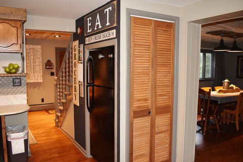 full size refrigerator, kitchen leads into open dining and living rooms