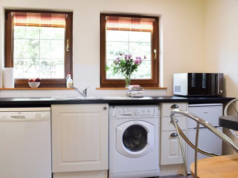 Kitchen with laundry facilities | Little Tigh Craggan - Tigh Craggan Cottages, Weem, near Aberfeldy
