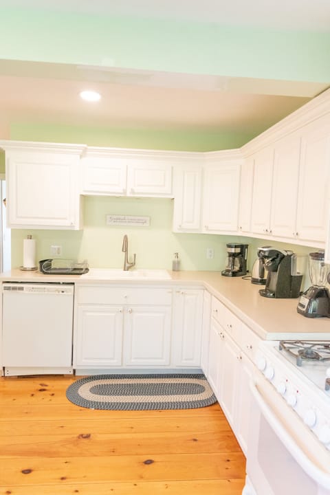 Bright kitchen with plenty of counter space, dishwasher and gas range