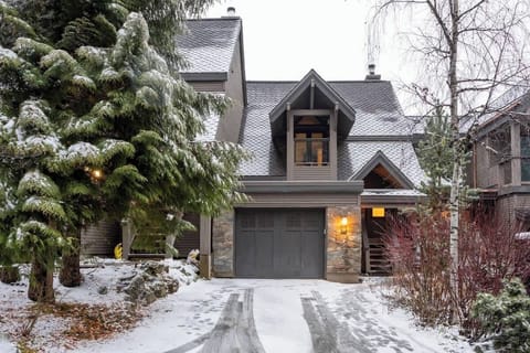 - Snow-covered chalet surrounded by evergreens, offering serene mountain charm  
- Steps from Whistler slopes and trails, perfect for winter adventures  
- Cozy retreat blending rustic stone with modern alpine architecture  
