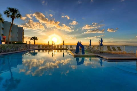 Poolside Paradise: Dive into bliss at sunset with stunning waterside views and lounging spots!