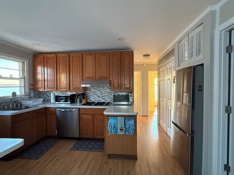 Kitchen with newer appliances. Looking down the hall to bedrooms and bathroom.