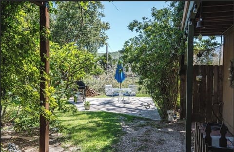 Out door patio space with beautiful trees and a creek in the back