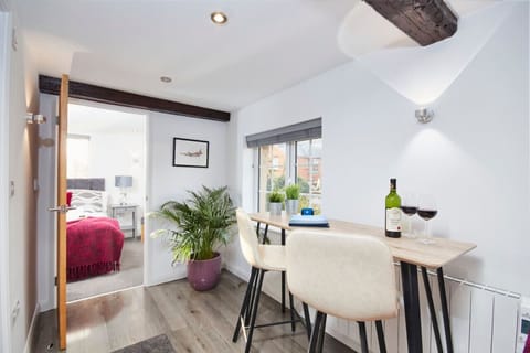 Beautiful kitchen/diner with versatile seating space looking over mature gardens