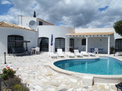 Dine al fresco beside the tear-drop shaped pool.
