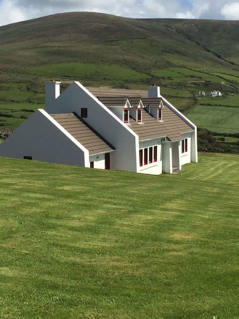 The house, surrounded by hills, looking out to sea