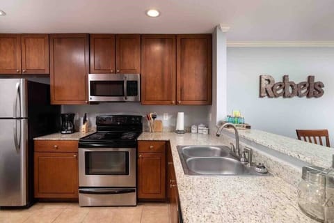 Full size kitchen with coffee maker, pots/pans, plates/cups, silverware, and cooking utensils.