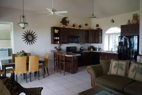 Great room.  Modern kitchen serves two dining area; one inside, one outside