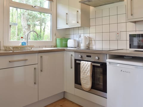Fully equipped kitchen with dining area within the open-plan design | Chalet 1 - Mount Hawke Holiday Bungalows, Mount Hawke, near Redruth