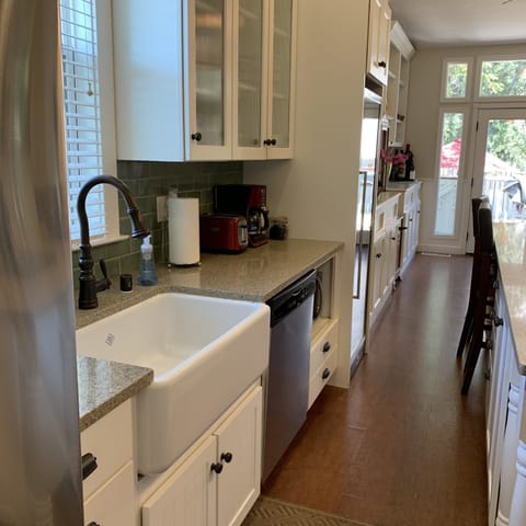 Farmhouse sink, dishwasher, coffee maker, toaster, microwave.