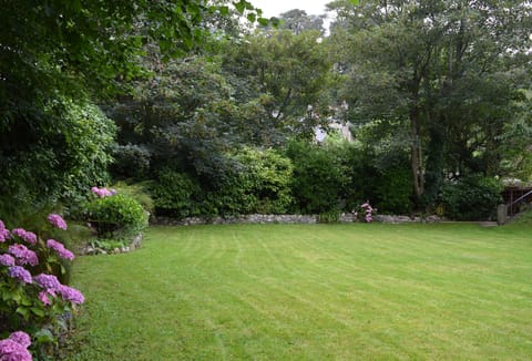 The house is surrounded by a large well stocked garden and two terraces