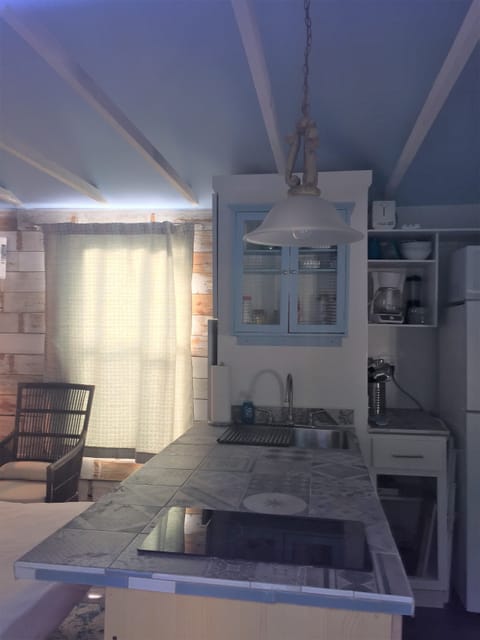 Kitchen island separates living area from rest of cottage.Coffee is ready!