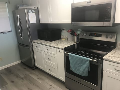Updated with new flooring, cabinets, granite, and stainless steel appliances. 