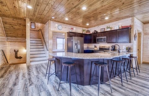 Kitchen peninsula has chairs for six.
