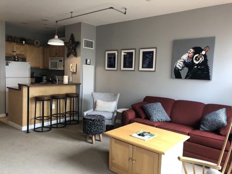 Living room with view of bar seating and kitchen