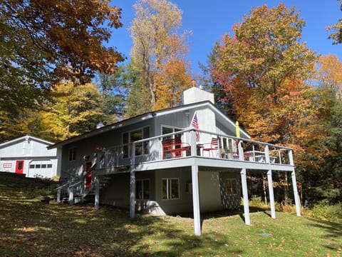 View of home from lower yard.  Huge deck with grill.  Swing under deck.