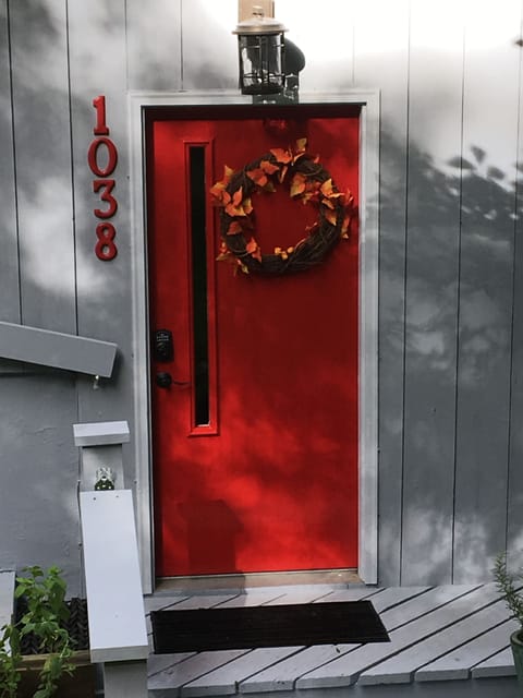 Cheerful front door.  Steps lead to the wrap around deck on the right.