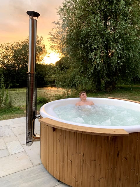 The wood fired hot tub overlooks the lake