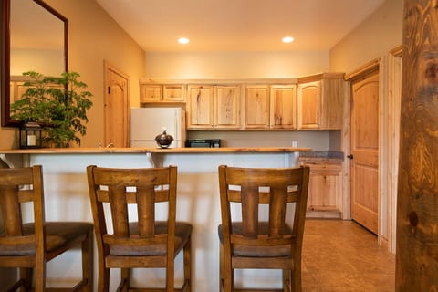 Downstairs bar with second refrigerator and microwave.