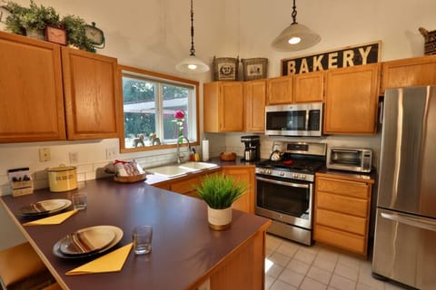 Kitchen with stainless steel oven, microwave, and refrigerator