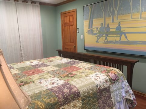 The closet has shelves for bags and clothing as well as extra linens and hangers