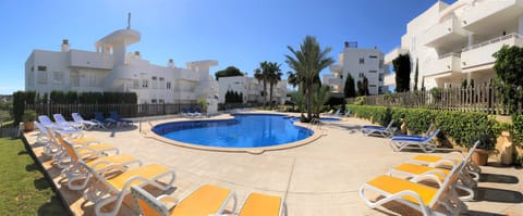 Residential El Puerto I community swimming pool with a large solarium area.