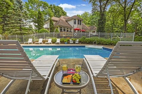 Fenced-in, heated salt-water pool with pool house, shower and plenty of seating!