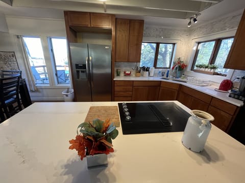 Kitchen has large quartz countertops and new range for cooking any sized meal