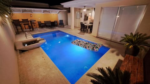 Pool area with fountain and coral stone deck, Smart TV and table