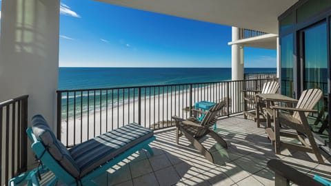 This ninth-floor balcony features comfortable seating with stunning beach views, perfect for enjoying the scenery