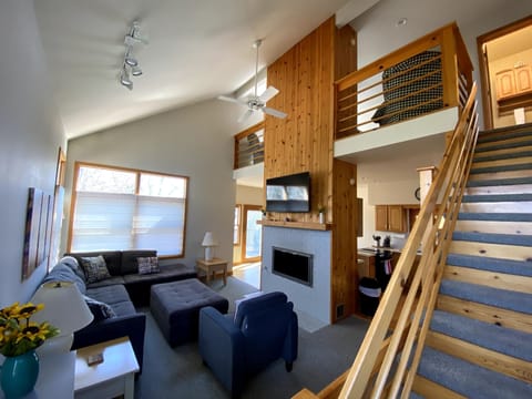 Vaulted Living room with gas fireplace, open to loft above
