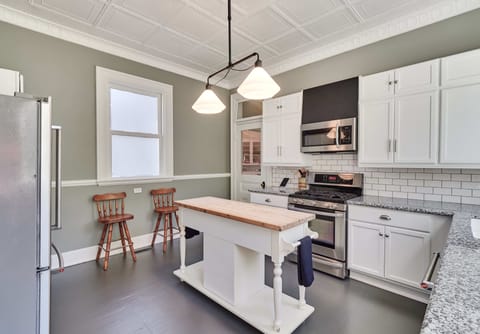 The white cabinets are stocked with all your kitchen needs