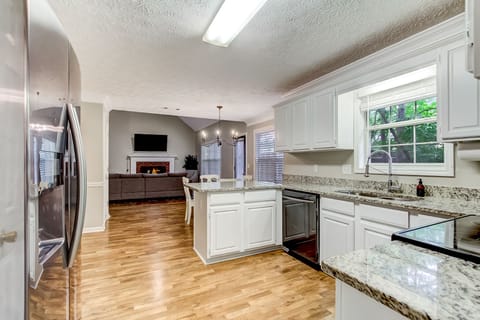 Kitchen with granite countertops open to living room