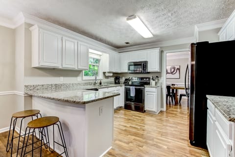 Kitchen with granite countertops open to living room