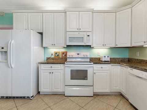 Kitchen with all the fixin's. Stovetop, oven, microwave, refrigerator!