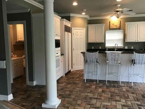 View of kitchen and restroom off den