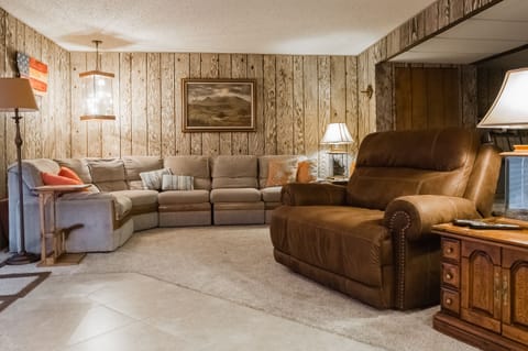 Comfortable seating in living room with French door access to outdoor patio.