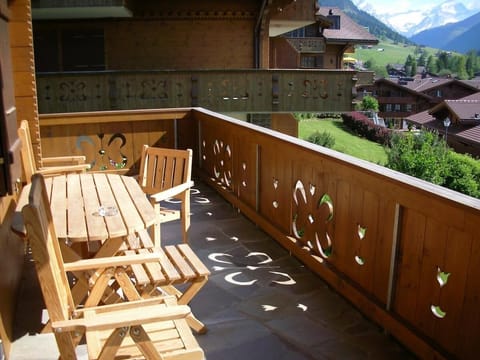 balcony sitting area in front of stunning mountain views on a sunny day 