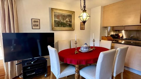 living room dinning table next to moveable tv 