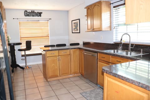 Shown is the kitchen with counter seating for 3 and bistro table seating for 2