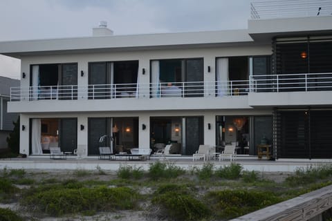 View looking back from walkway to beach. Top doors are 4 upstairs bedrooms. 
