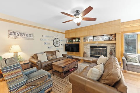 Sink into plush leather seating by your stone fireplace, where rustic charm meets modern comfort in this inviting living space.