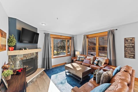 Cozy up in your mountain retreat with plush leather seating, crackling fireplace, and beautiful windows framing scenic views.