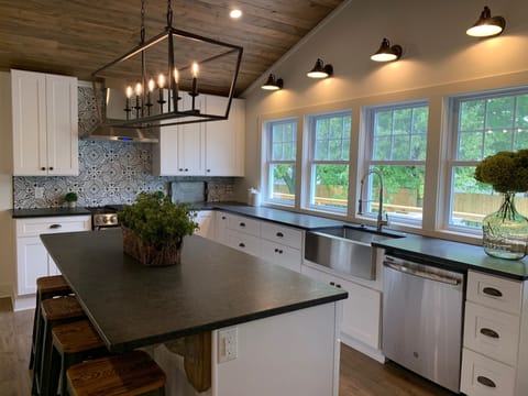 Kitchen windows provide scenic views of the lush backyard.