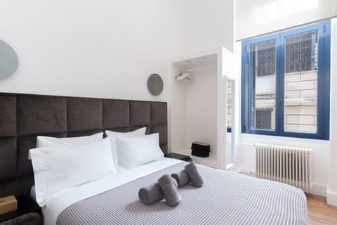 Bedroom and the high windows overlooking the streets of Plaka