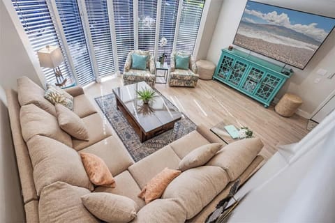 Unwind in this spacious Maui living room featuring a plush sectional and bright natural light. Perfect for family movie nights, the very large smart TV offers endless entertainment after sun-filled island adventures. Comfort and style meet paradise!