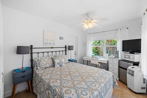Bedroom with queen bed and work space.