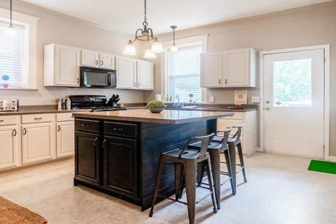 A central kitchen island complete with granite countertops.