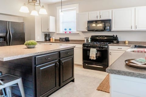 The kitchen is fully equipped with modern cooking appliances.