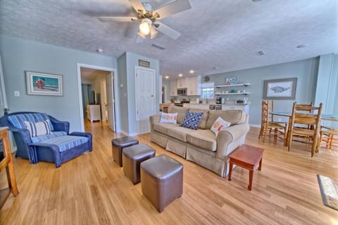 Open-concept living meets cozy charm in this inviting space, perfect for unwinding or enjoying meals with loved ones